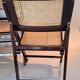 Pair of caned folding chairs from the 1960s in varnished wood.