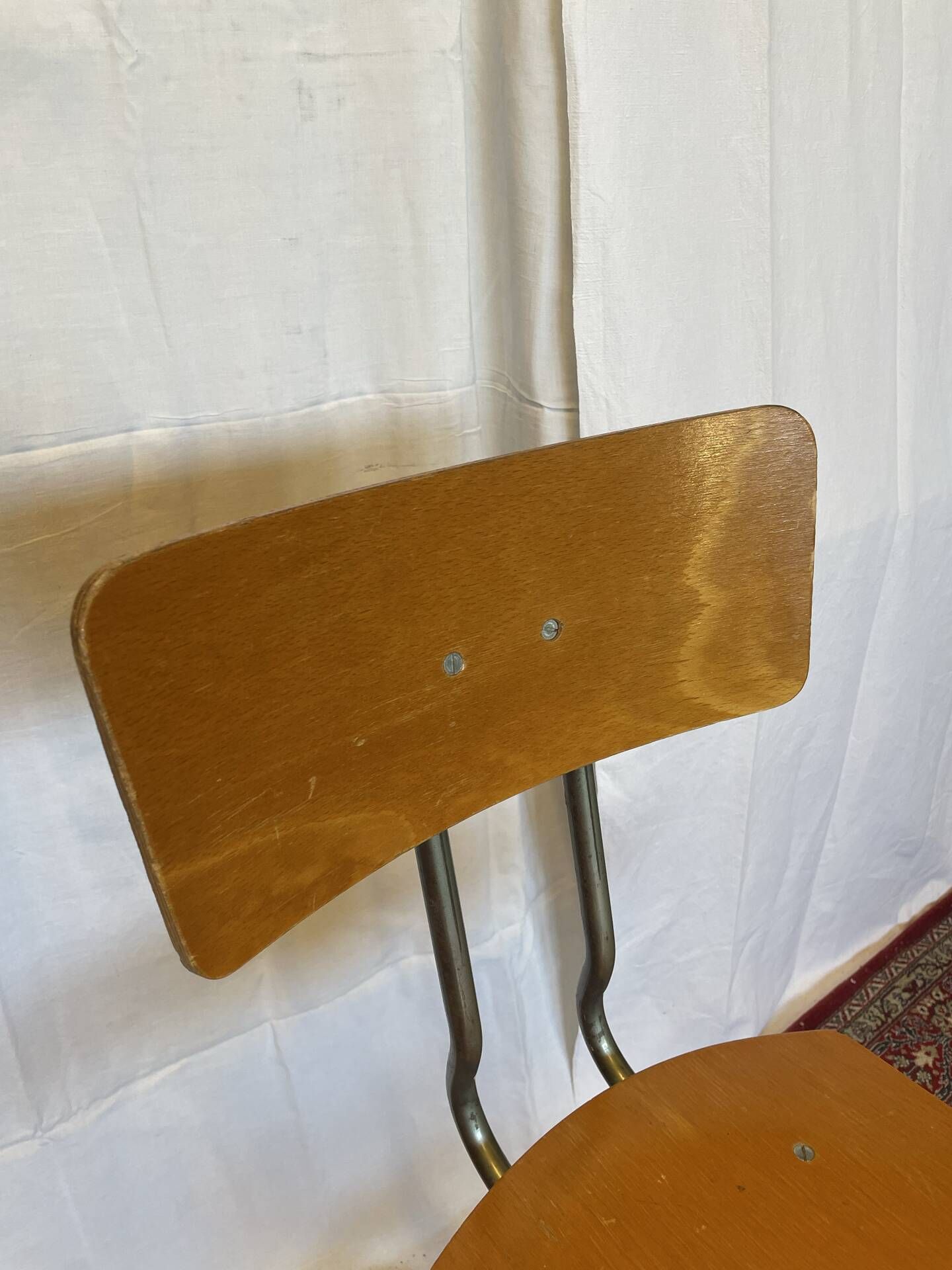Old high workshop chair made of wood and metal.
