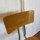 Old high workshop chair made of wood and metal.