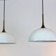 Paire de suspensions en laiton et verre opale blanc par Florian Schulz