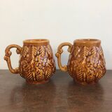 Set of 2 vintage caramel-colored slip mugs with flower pattern