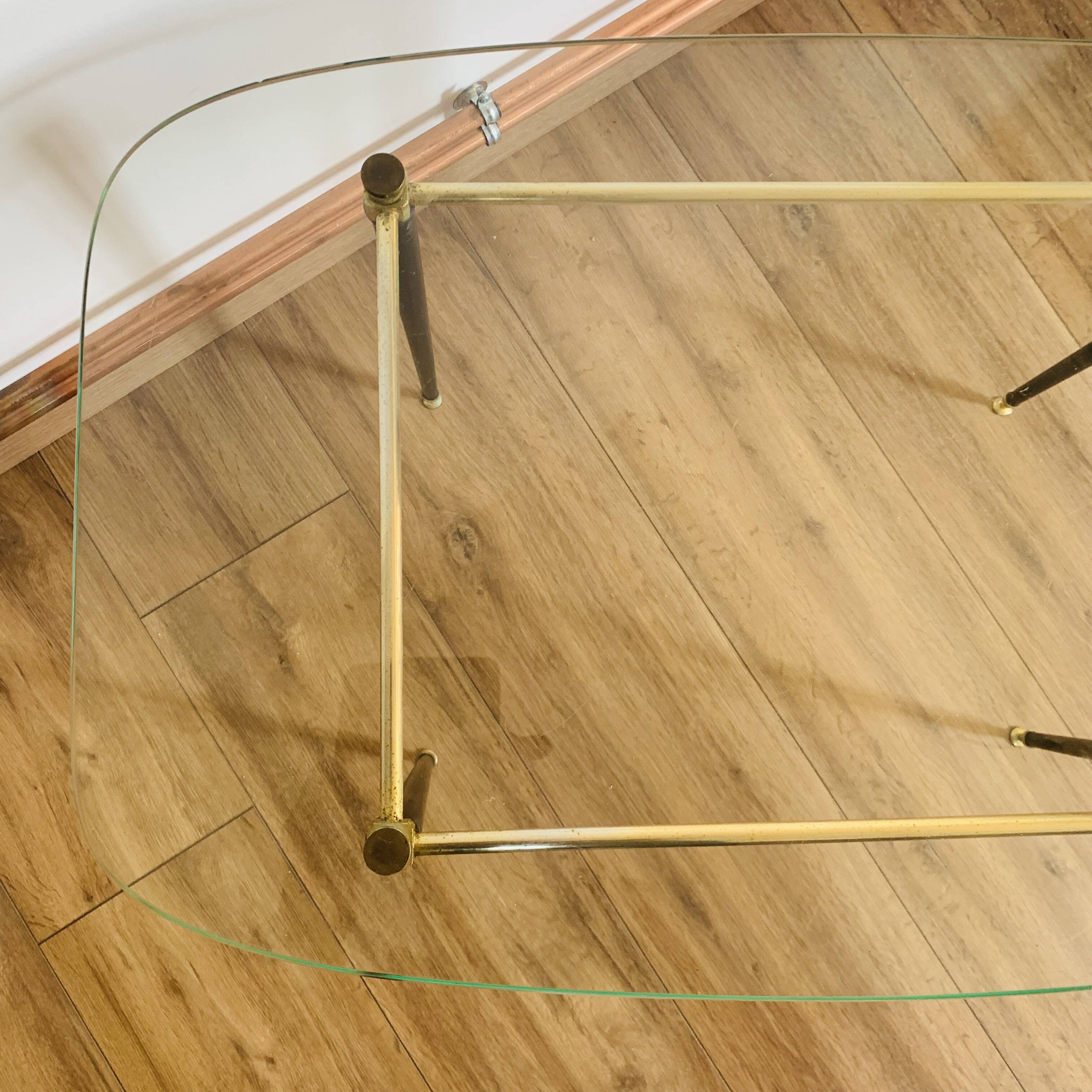 Coffee table from the 50s/60s, glass, brass, black metal.