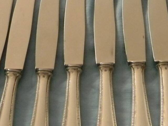 Set of 12 cheese or fruit knives with silver metal handles.