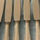 Set of 12 cheese or fruit knives with silver metal handles.