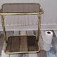 Pair of vintage smoked glass and brass bedside tables