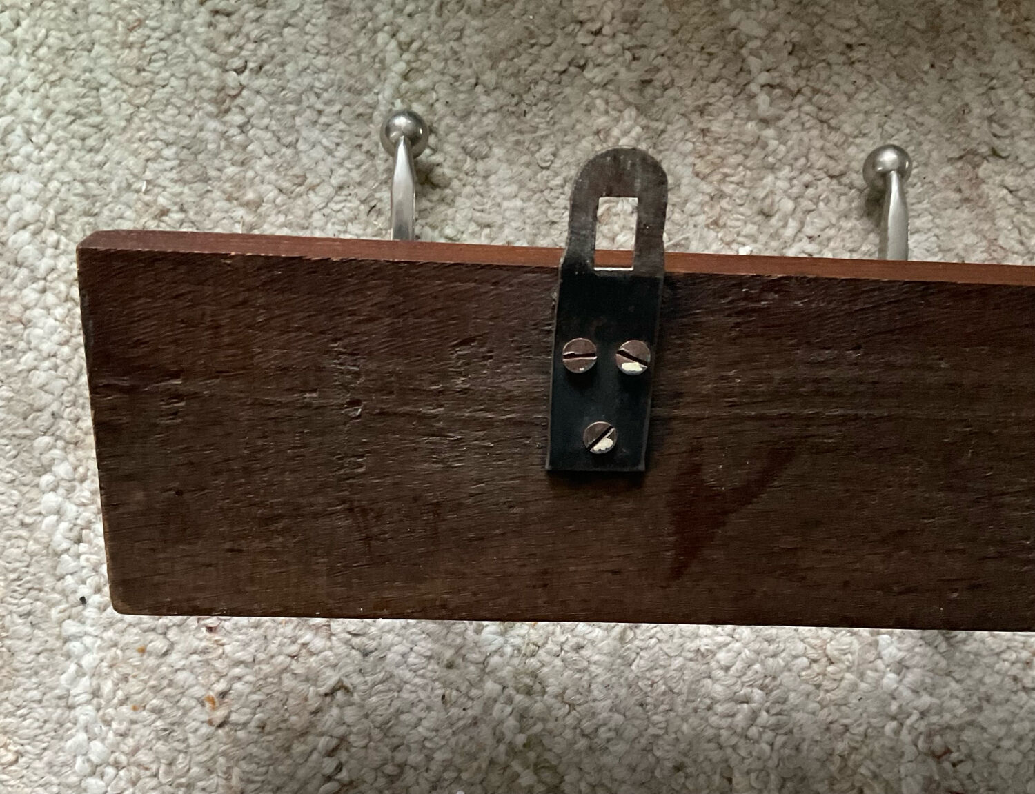 Wall coat rack from the 1950s-60s in solid oak and stainless steel.