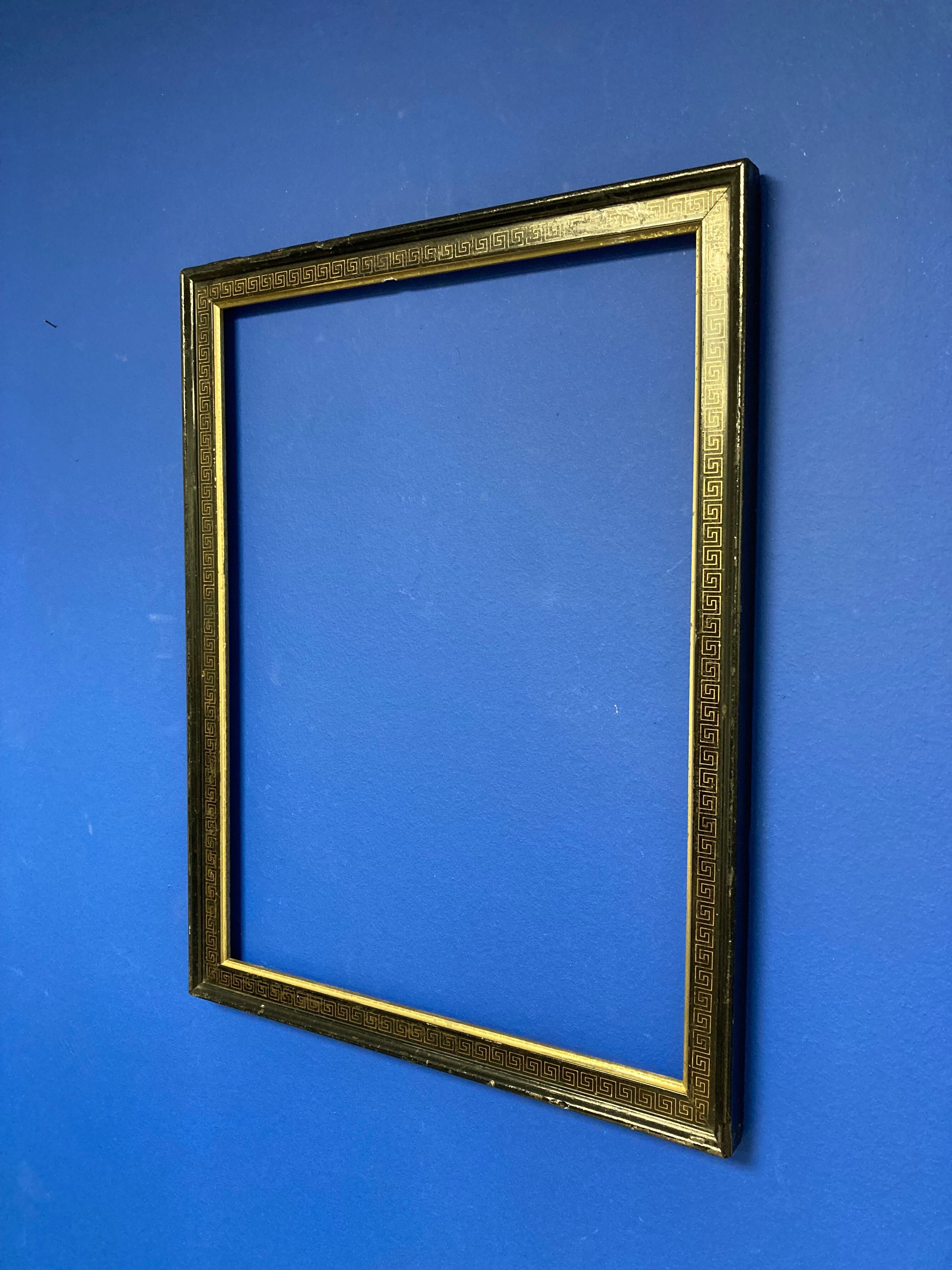 Black and gold frame decorated with Greek frieze decoration