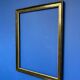 Black and gold frame decorated with Greek frieze decoration