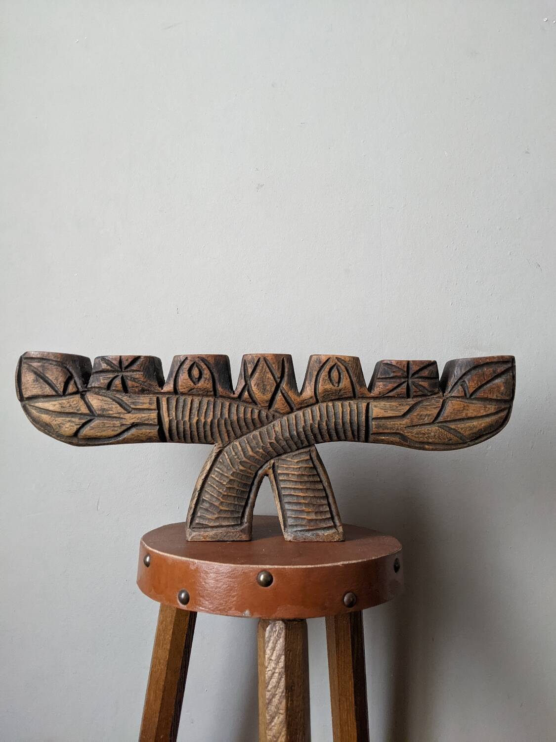 Hand-carved wooden candle holder, ethnic tribal style.