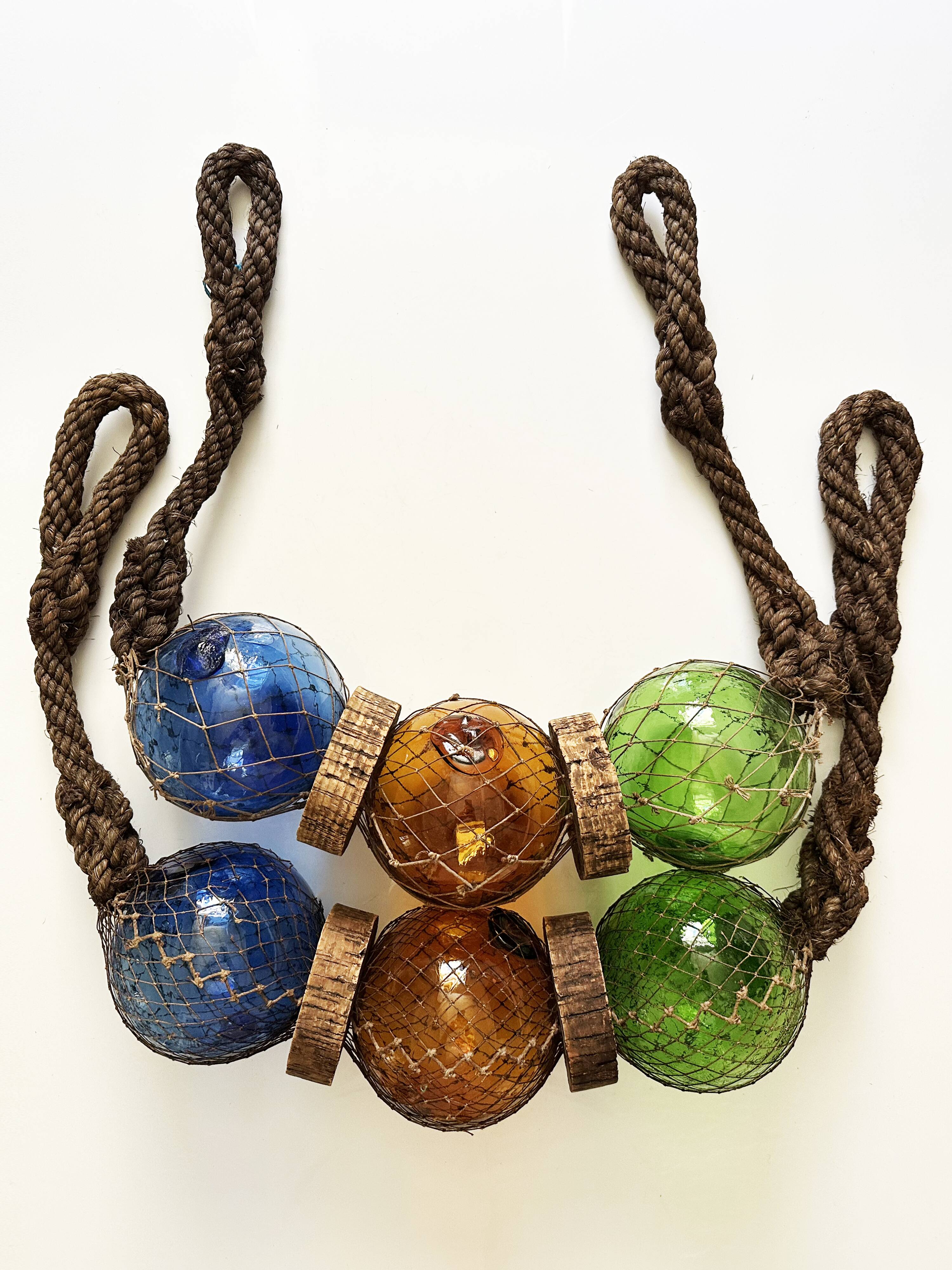 Fishing floats made of blown glass, cork, and rope. France, 1960s.