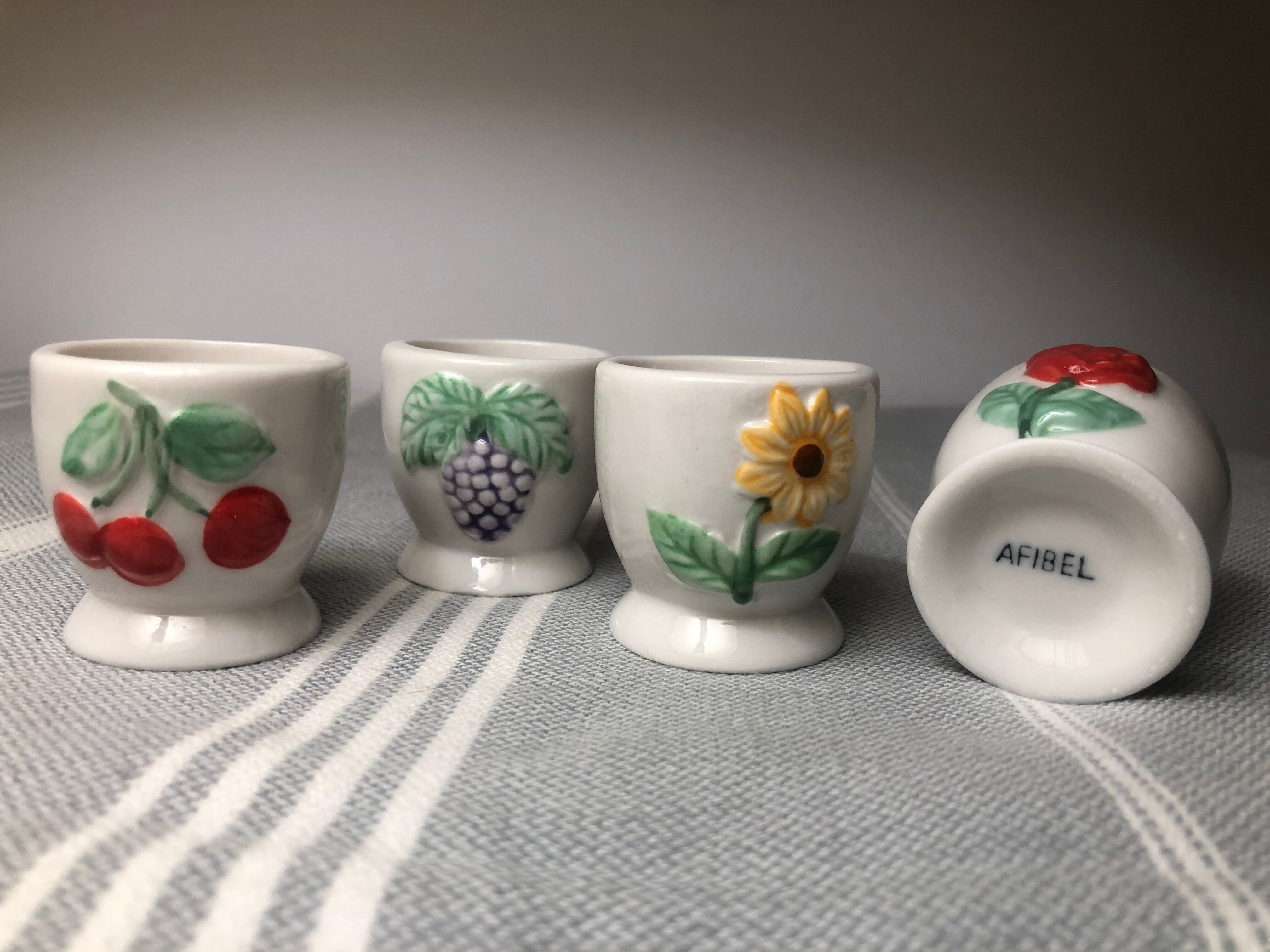 Ceramic shells with relief decoration of flowers (yellow and red) and fruits (cherries and grapes)