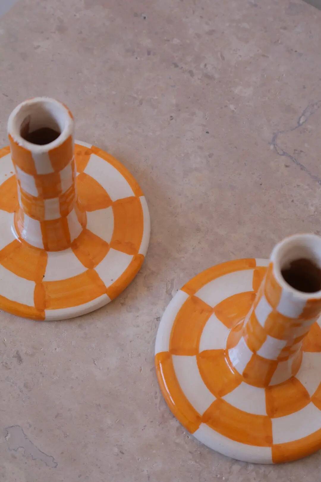 Pair of yellow and white checkered ceramic candlesticks