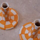 Pair of yellow and white checkered ceramic candlesticks