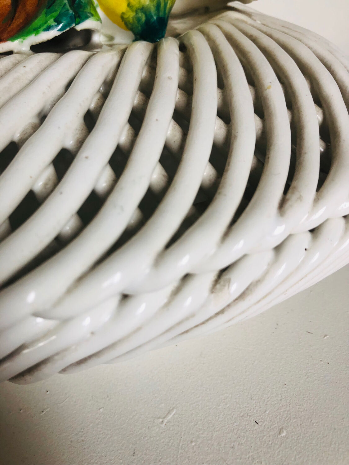 Covered basket in woven ceramic and fruit slip.