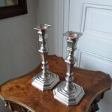 Pair of silver-plated metal candlesticks with cut sides