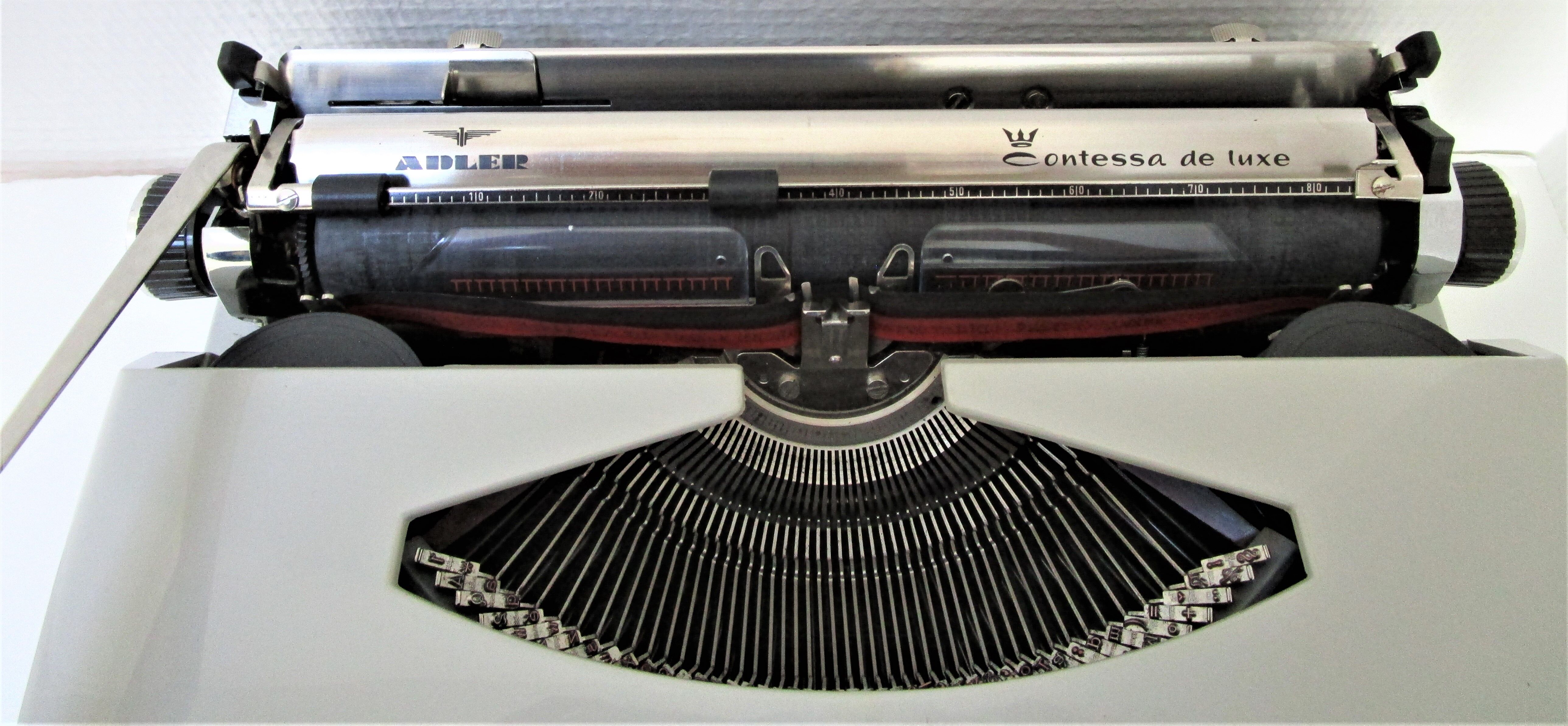 Writers' typewriters of light grey 70s Adler made in Holland
