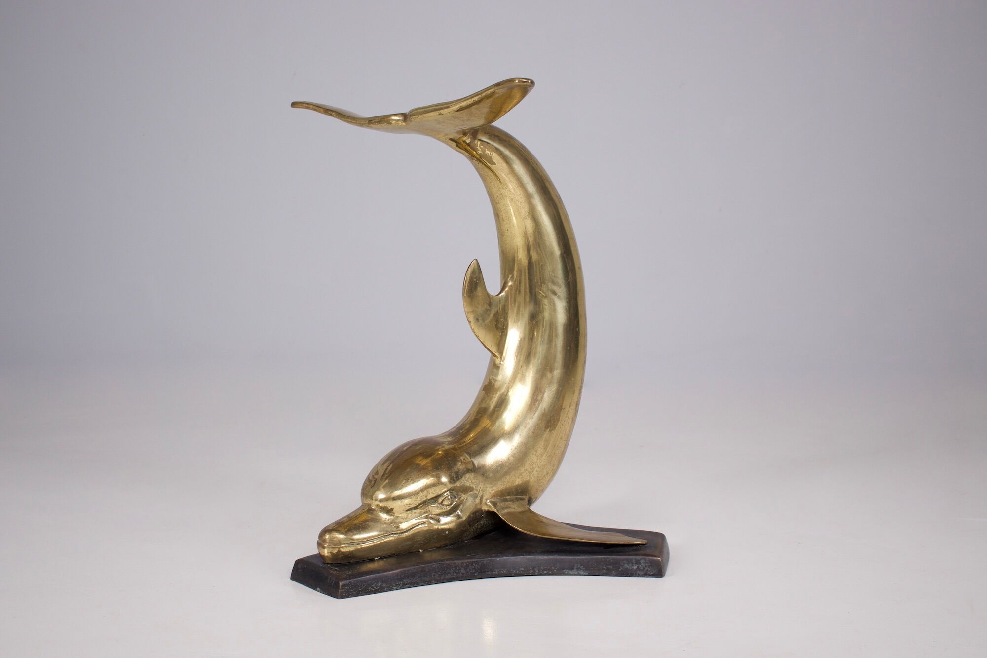 Solid brass dolphin console feet.