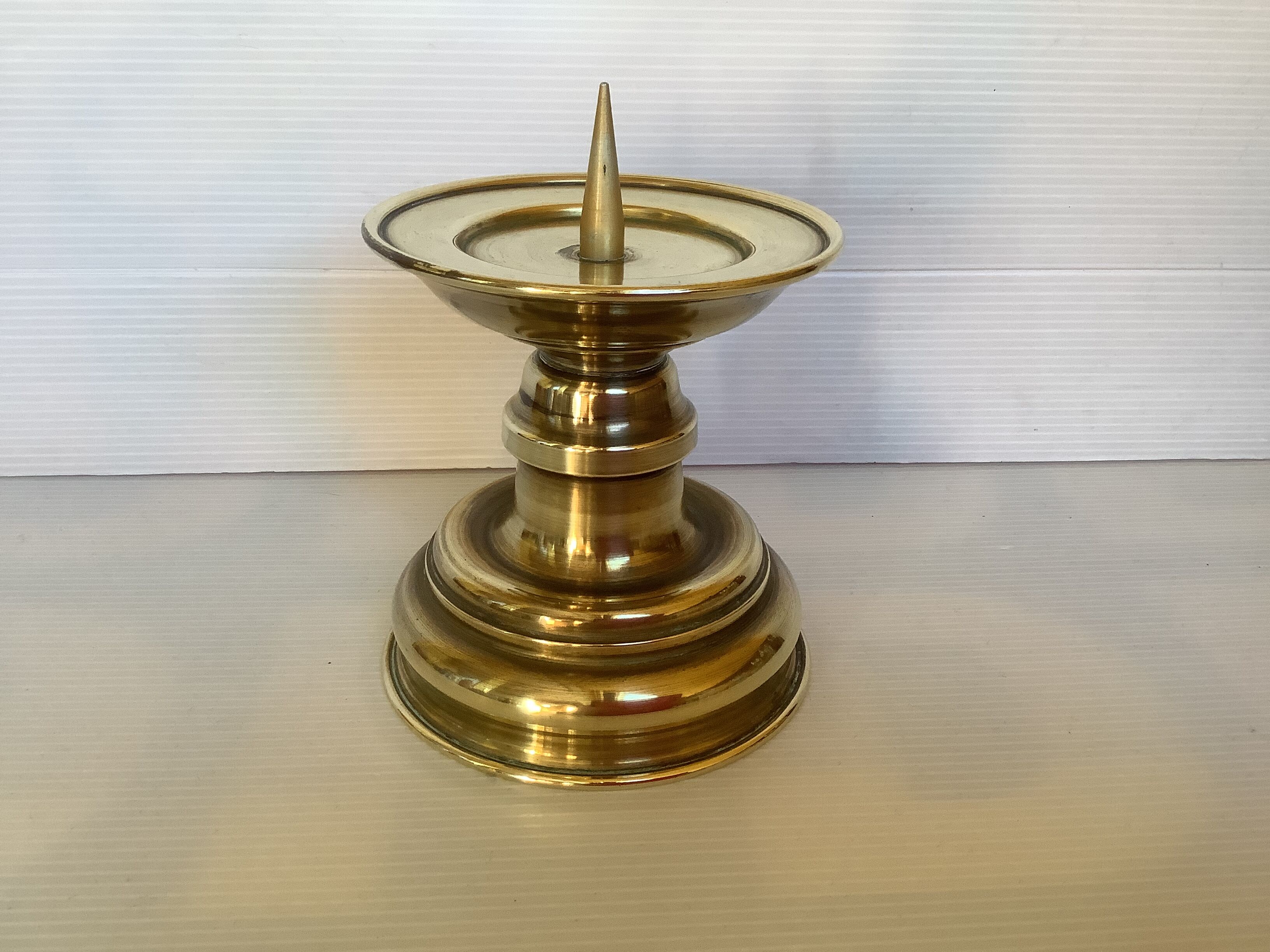 Old brass candle pique