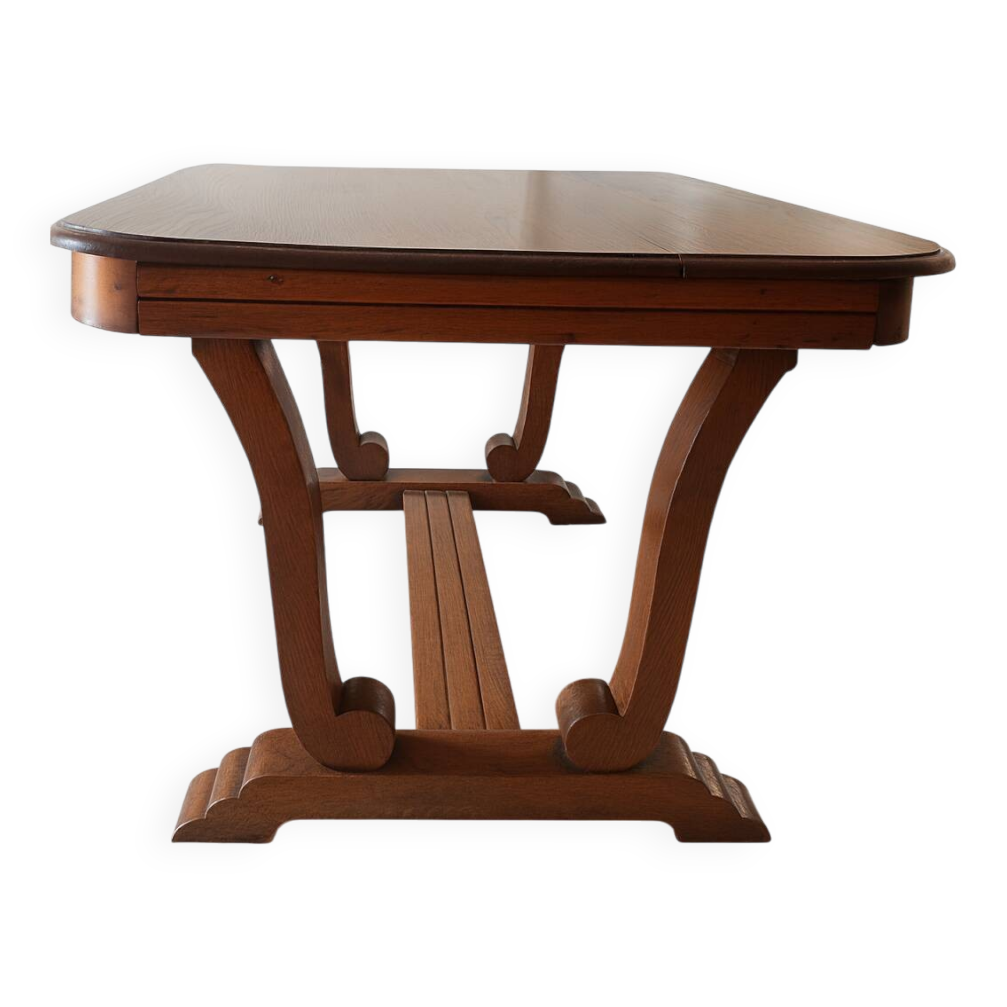Solid wood dining table with a sculptural base.