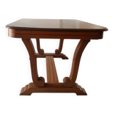 Solid wood dining table with a sculptural base.
