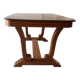 Solid wood dining table with a sculptural base.