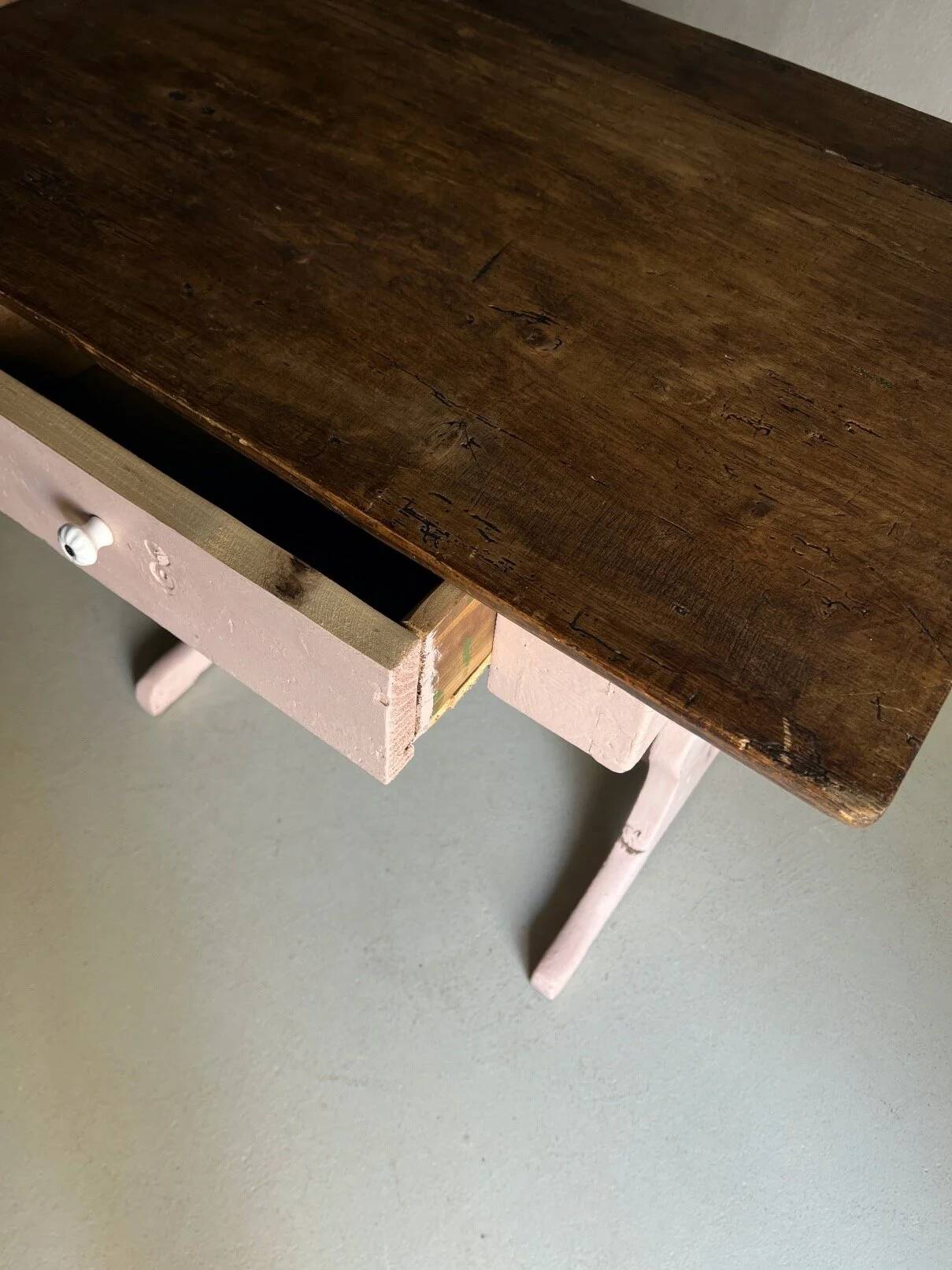 Rustic pink painted desk with brown tabletop