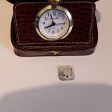 Small travel alarm clock in its case with jewelry compartments