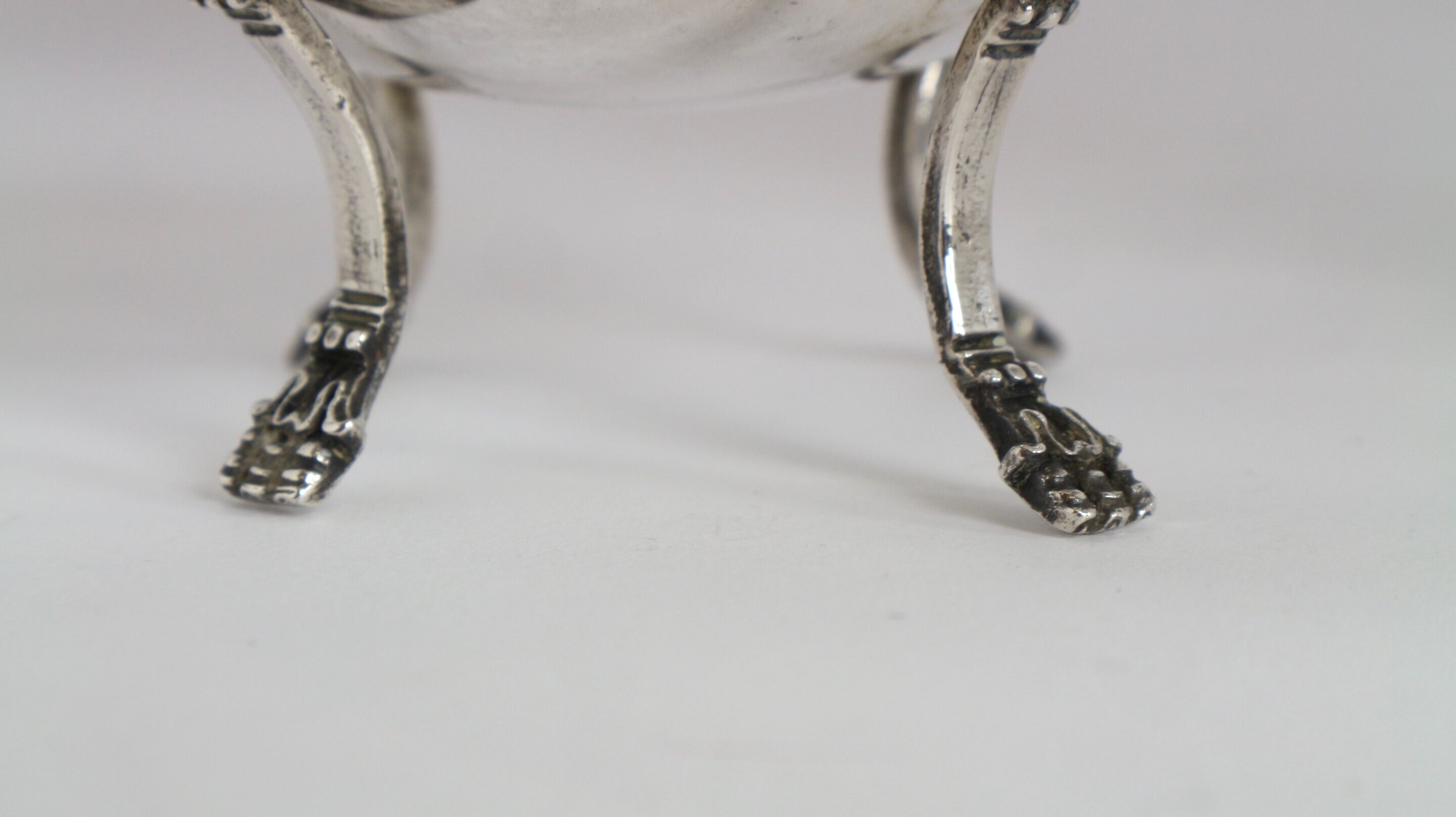 Silver sugar bowl with paw feet and ornate handles