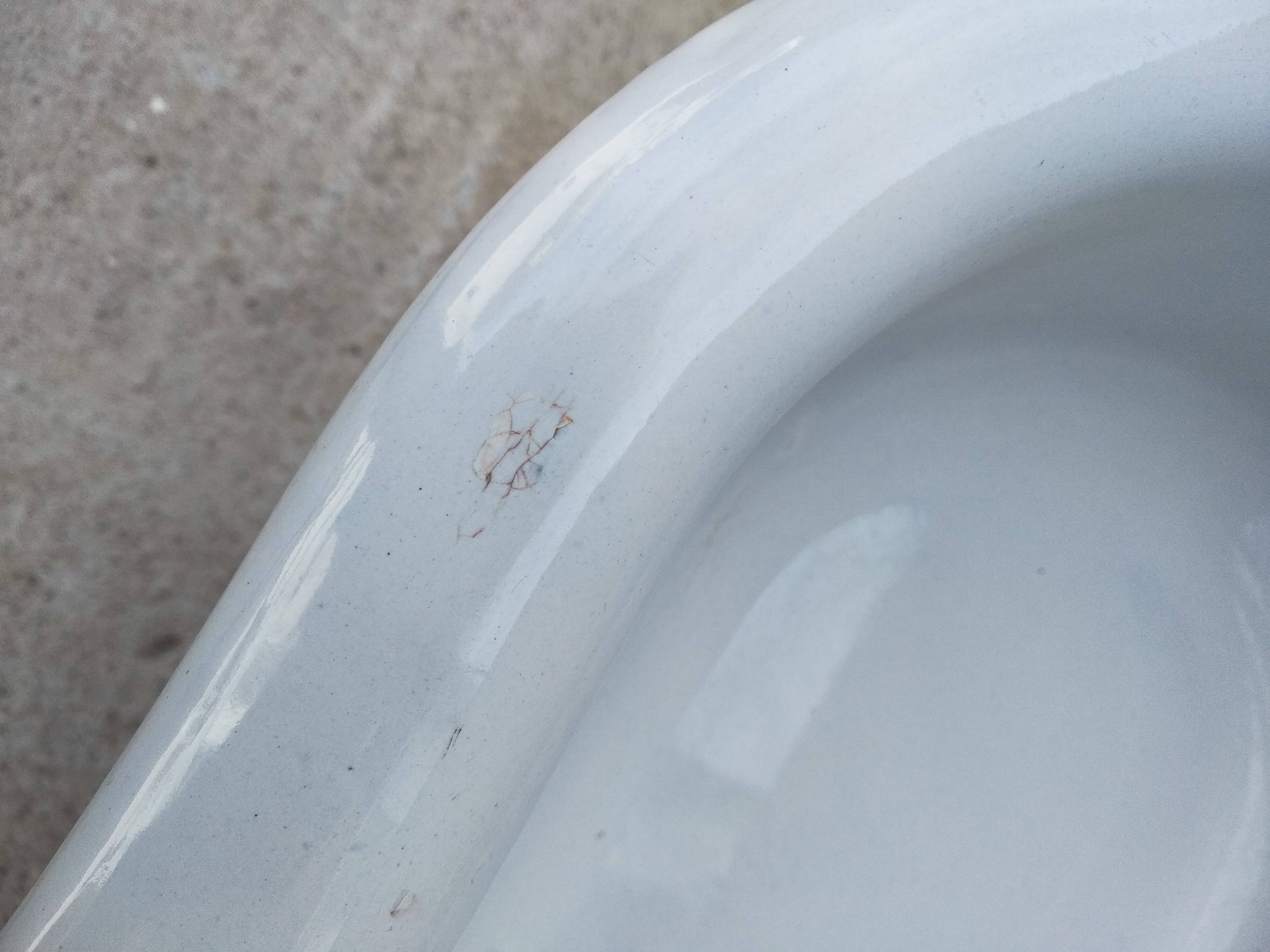 Antique bidet in enamelled sheet metal with wrought iron support