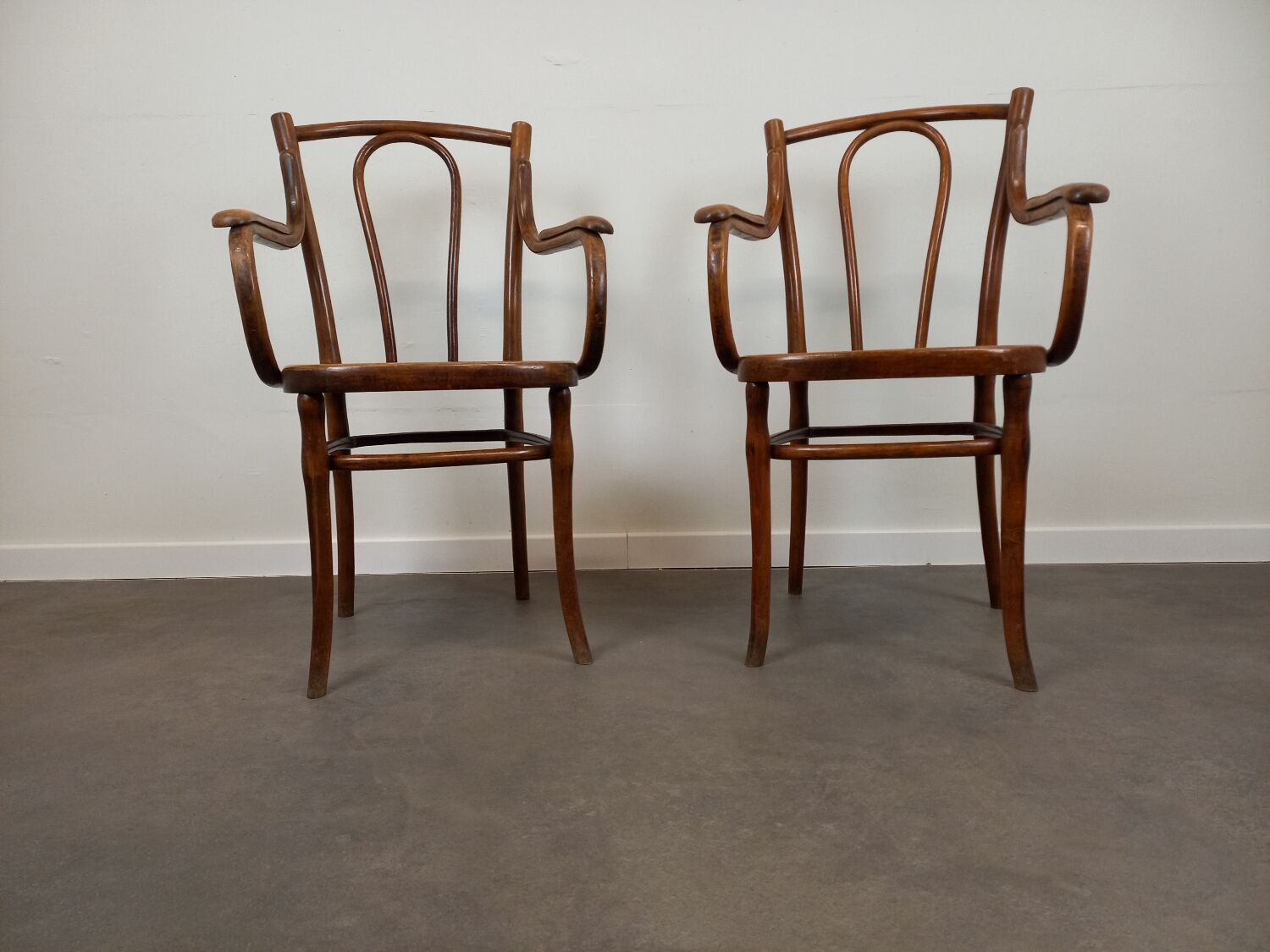 Pair of curved wooden bistro armchairs