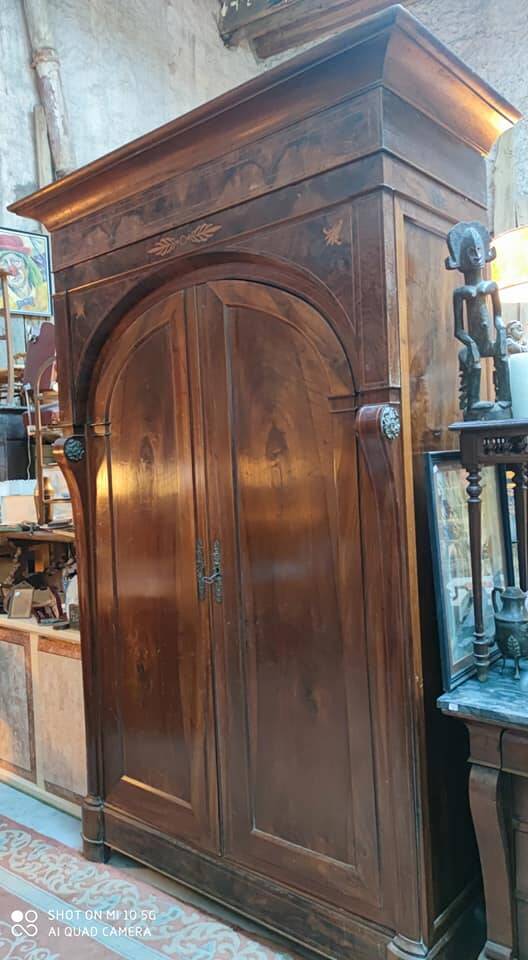 A walnut wardrobe with marquetry and boxwood stringing, dating from the Consulate period, circa 1810.