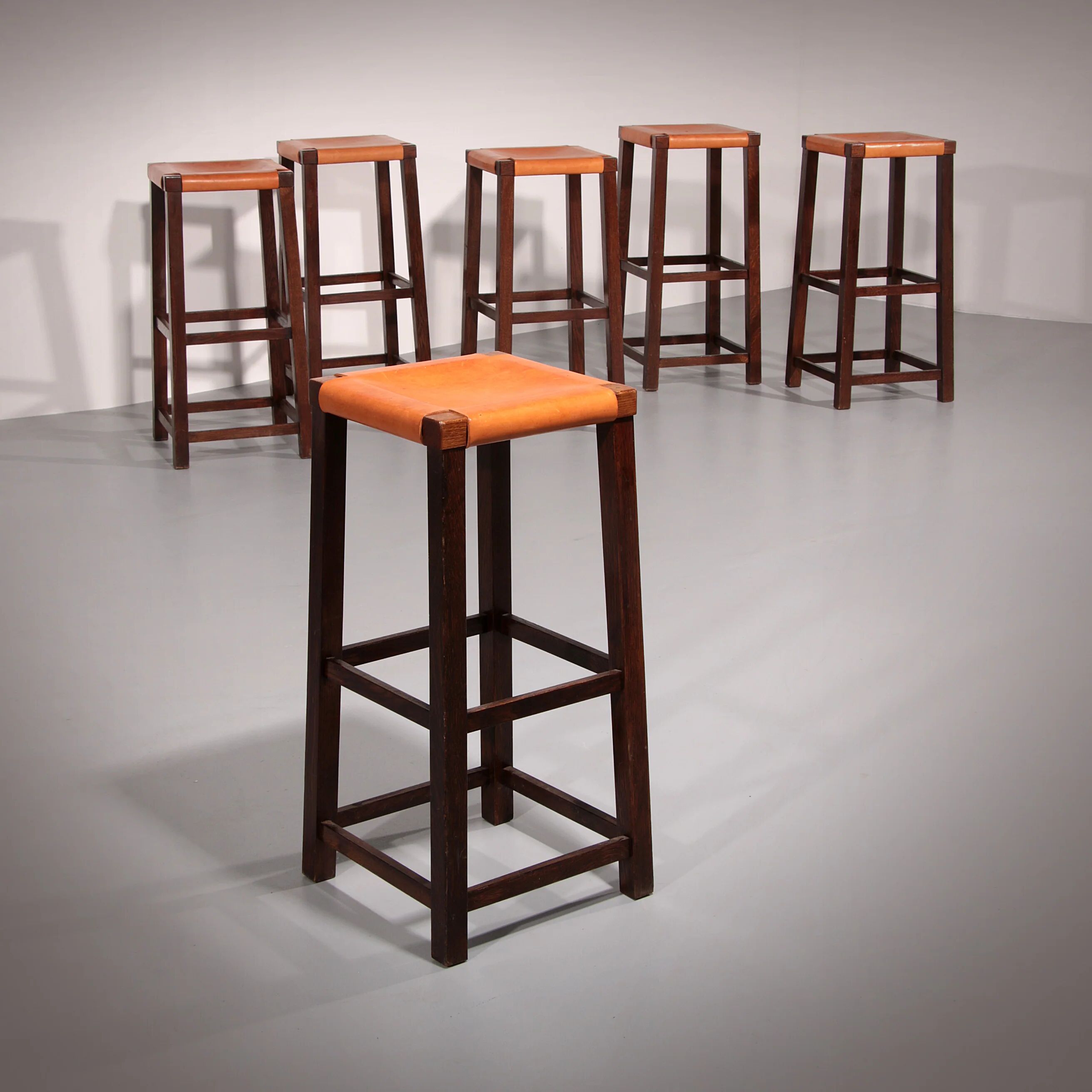 Mid-century oak bar stools with cognac leather seats