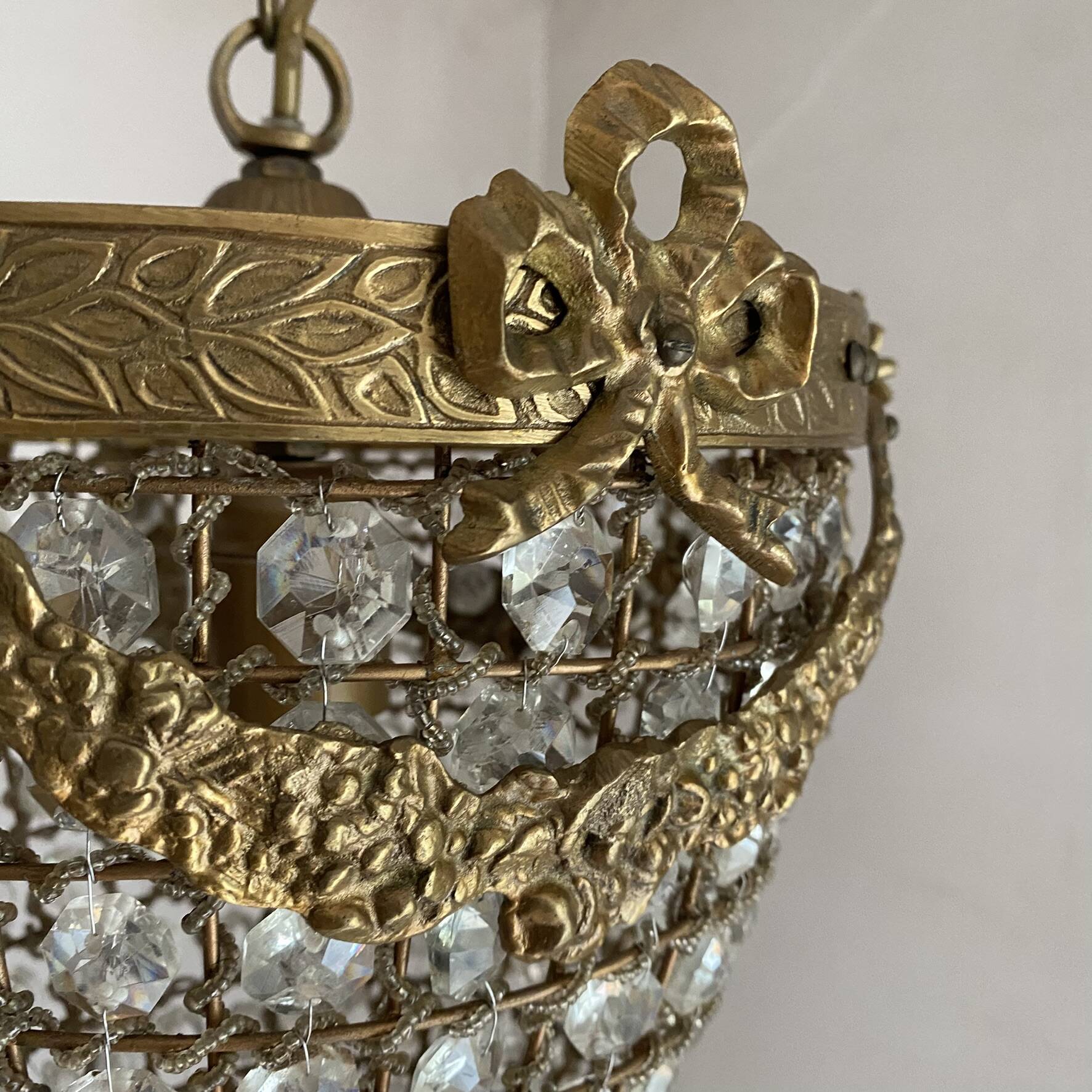 Brass basket chandelier with Louis XVI style pendants.