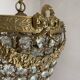 Brass basket chandelier with Louis XVI style pendants.