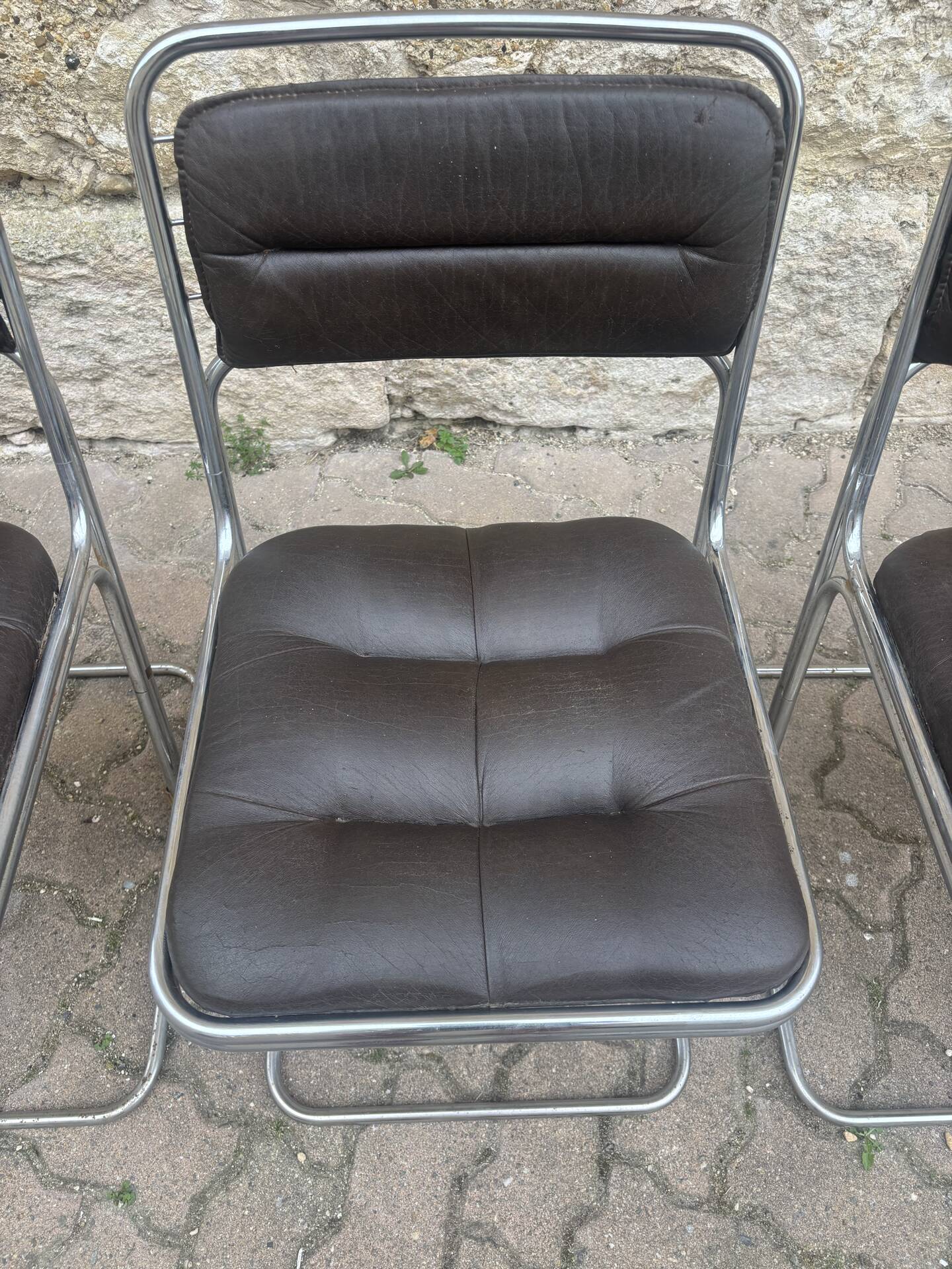 Four vintage chairs from the 1960s and 1970s, chrome with faux leather.