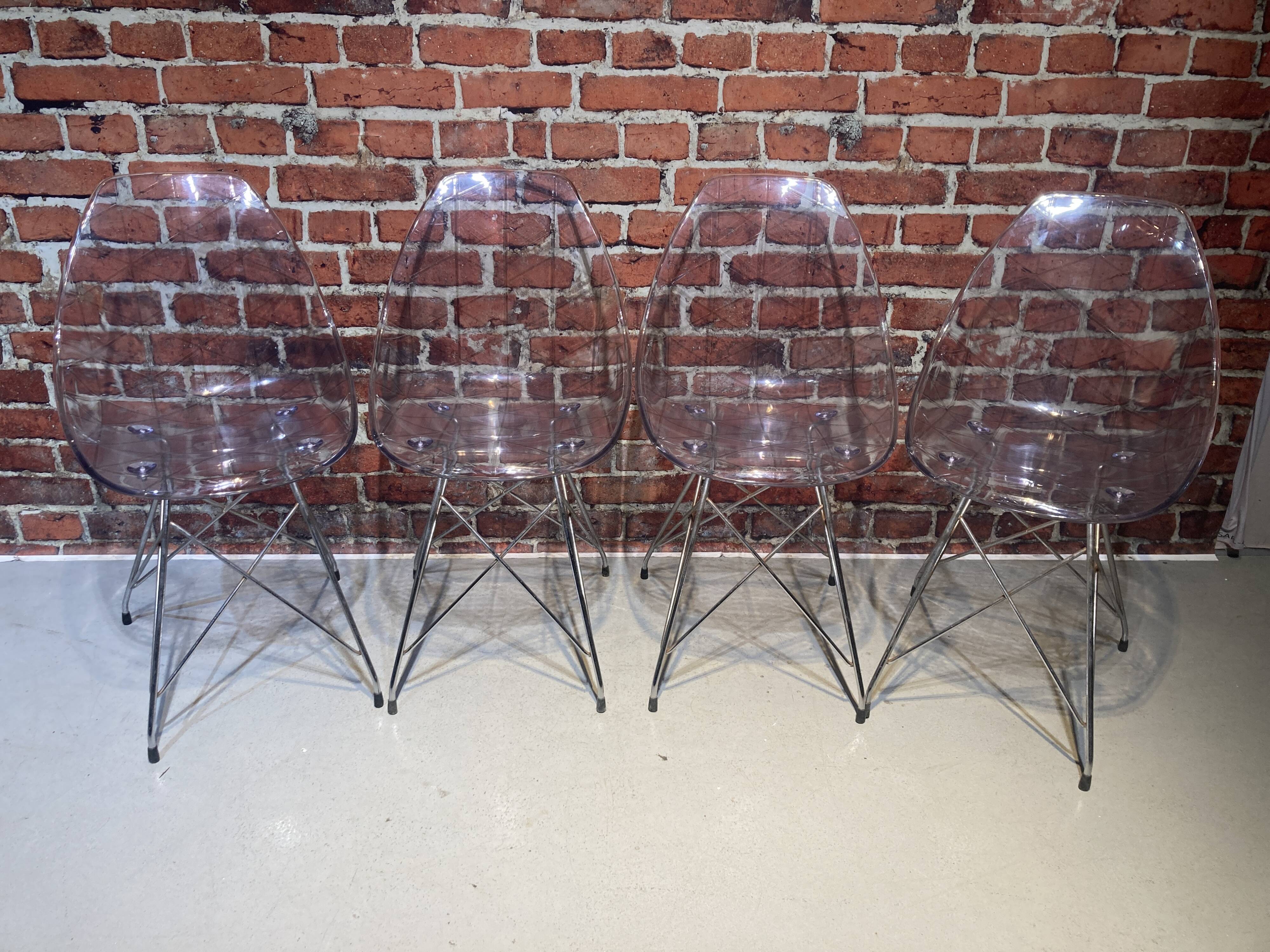 Set of four plexiglass and metal chairs
