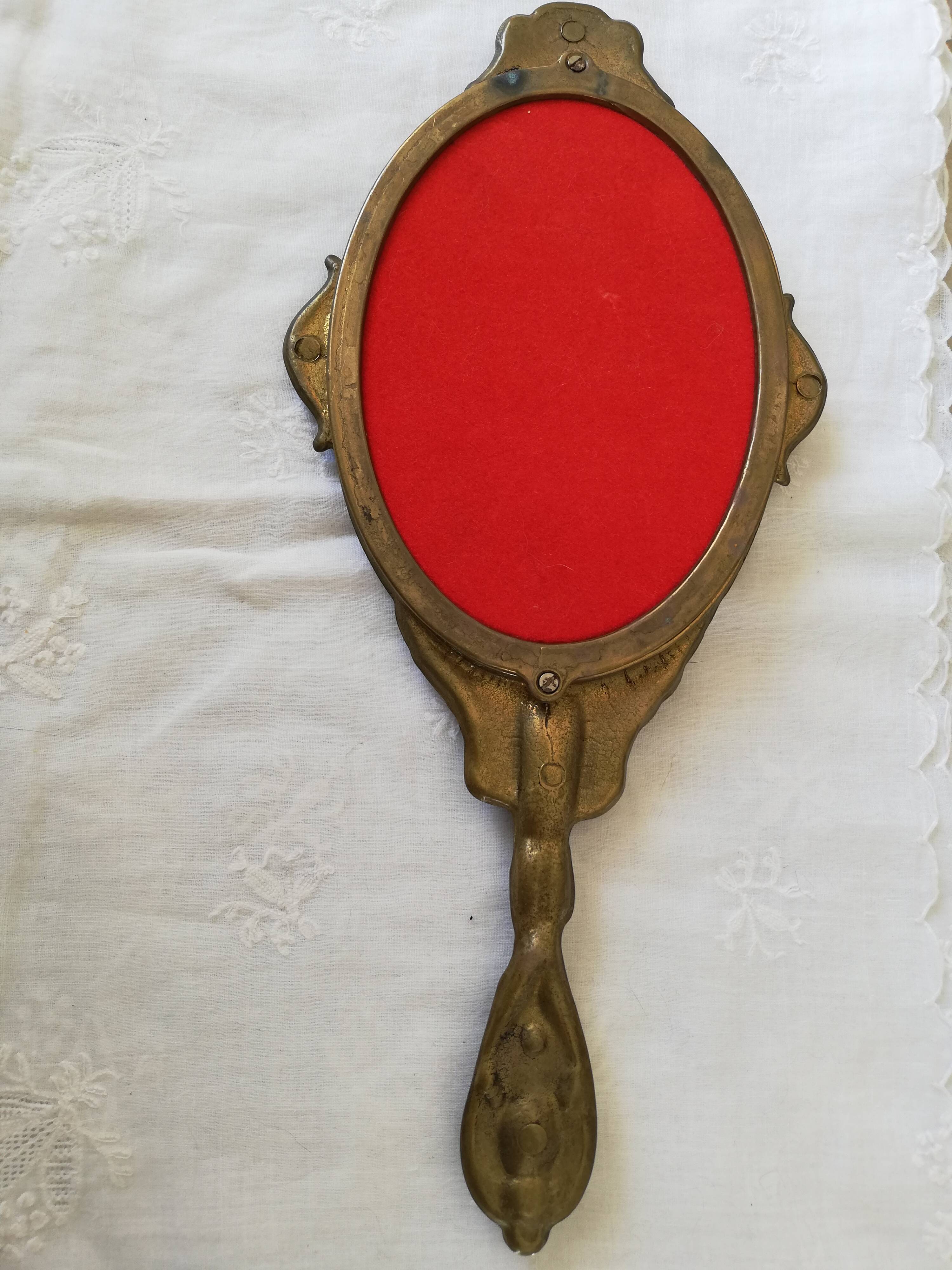 Old hand-facing mirror in gilded bronze