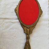 Old hand-facing mirror in gilded bronze