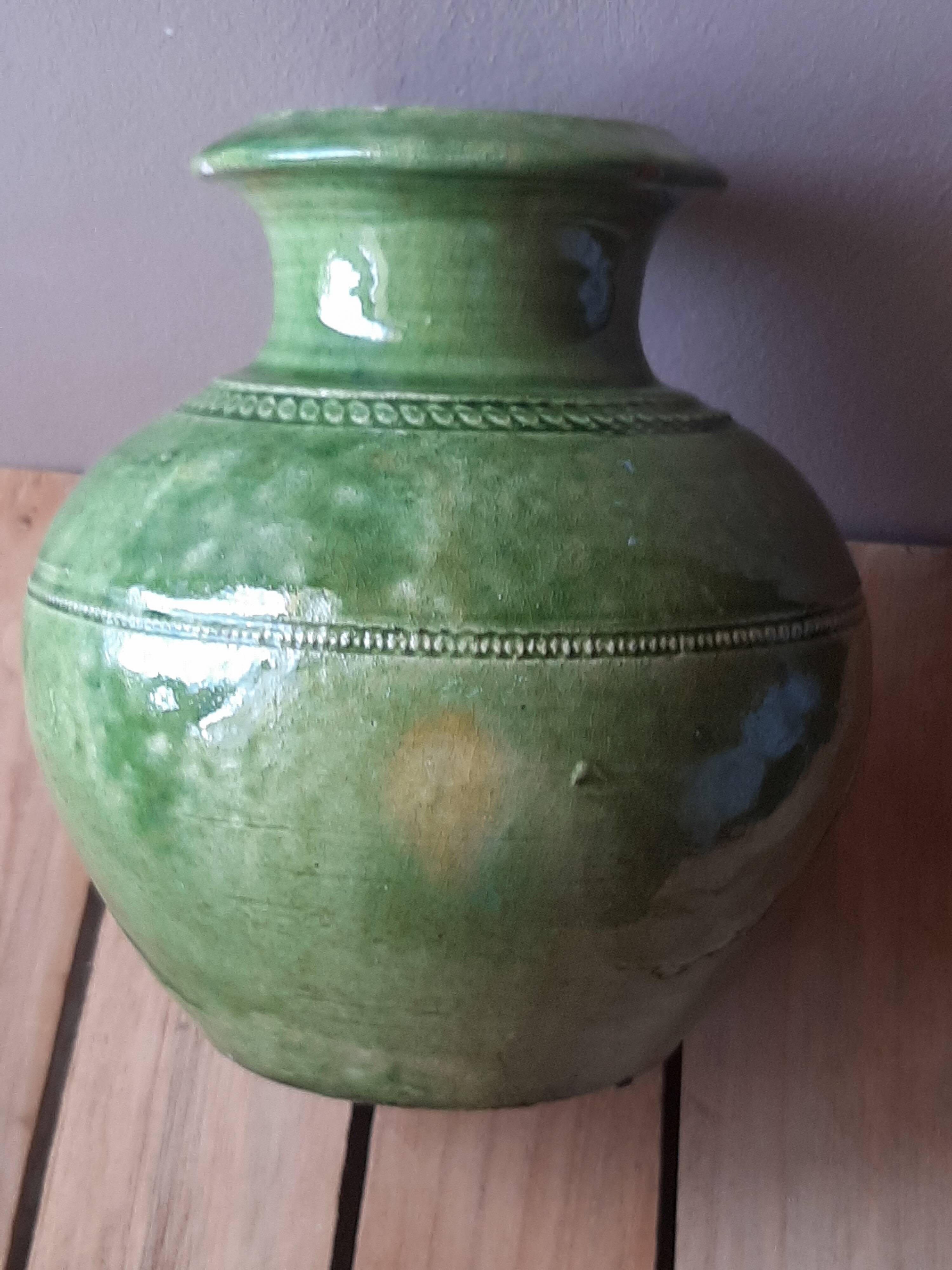 Ancient vase in glazed terracotta with green glaze.