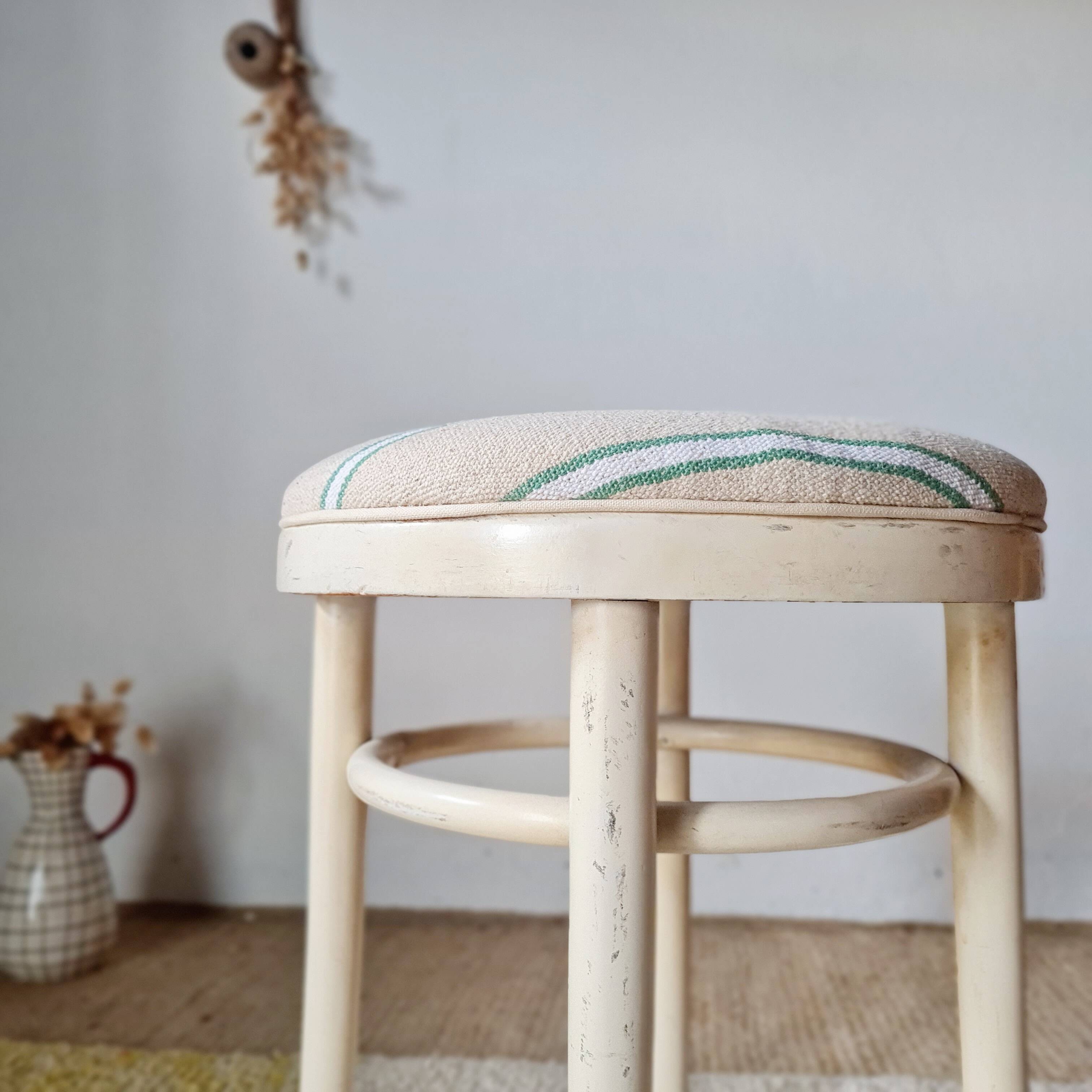 Vintage curved wooden stool in Baumann style, striped fabric seat.