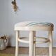 Vintage curved wooden stool in Baumann style, striped fabric seat.