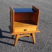 Vintage oak bedside table with tapered legs.