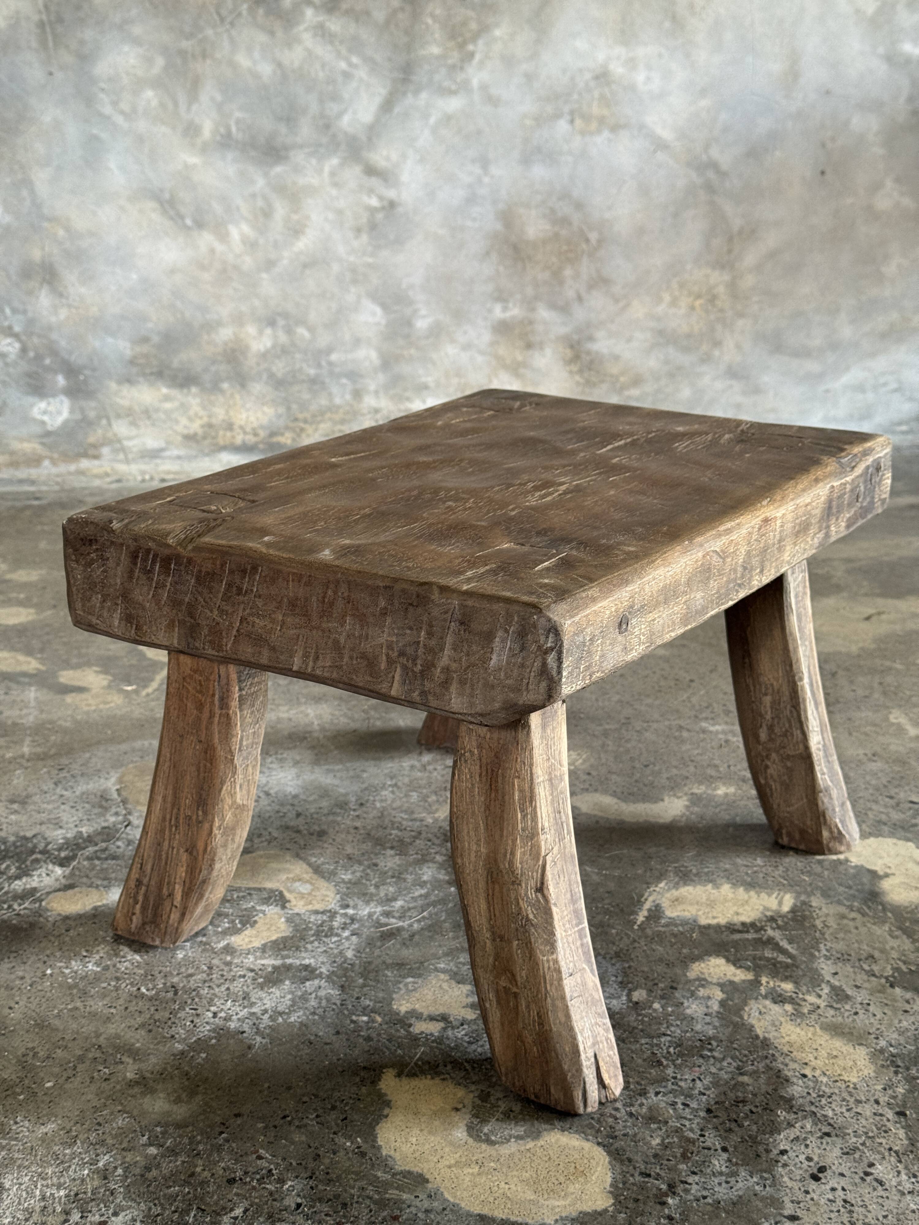 Small stool, rectangular solid teak side table with curved legs.