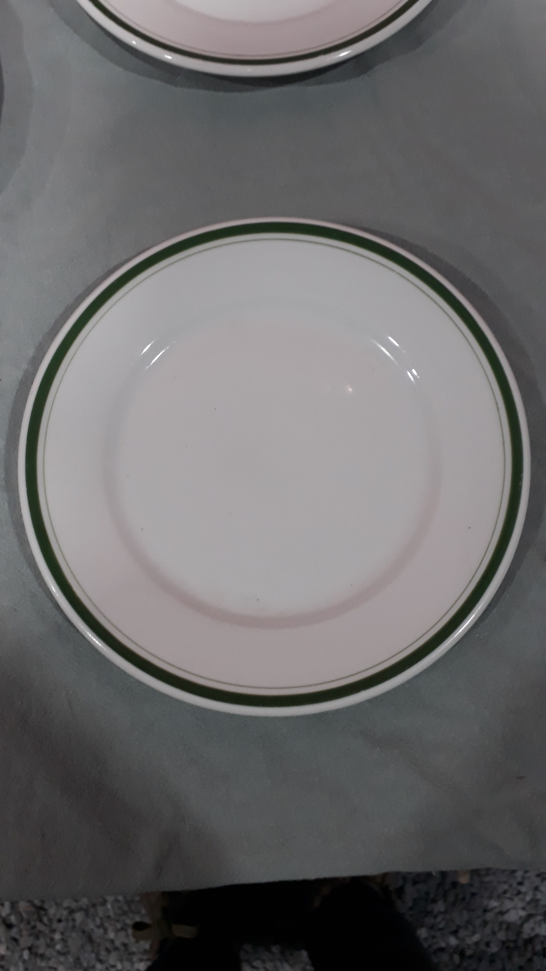 3 plates in white porcelain and green edging