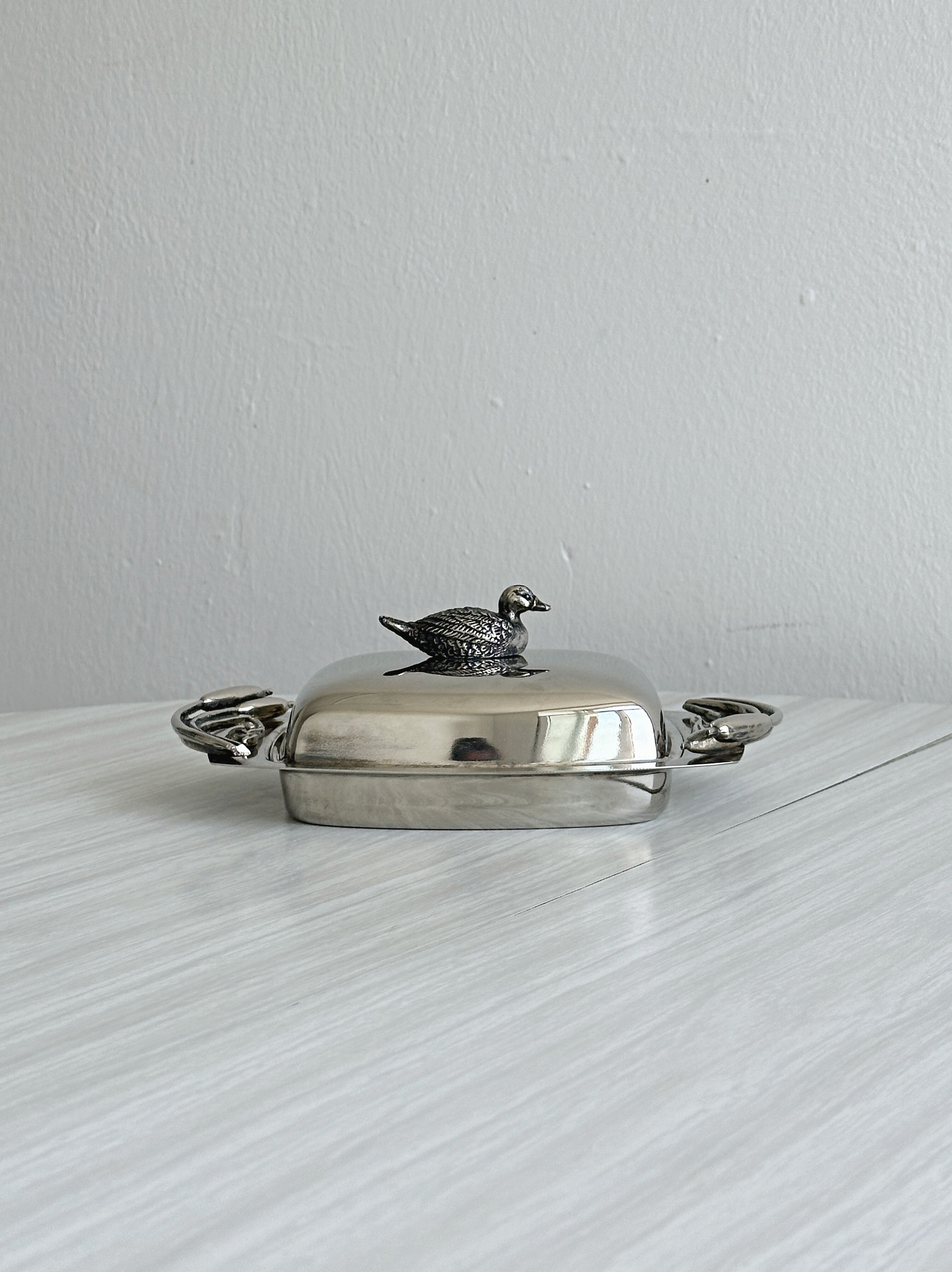 Antique shiny metal butter dish