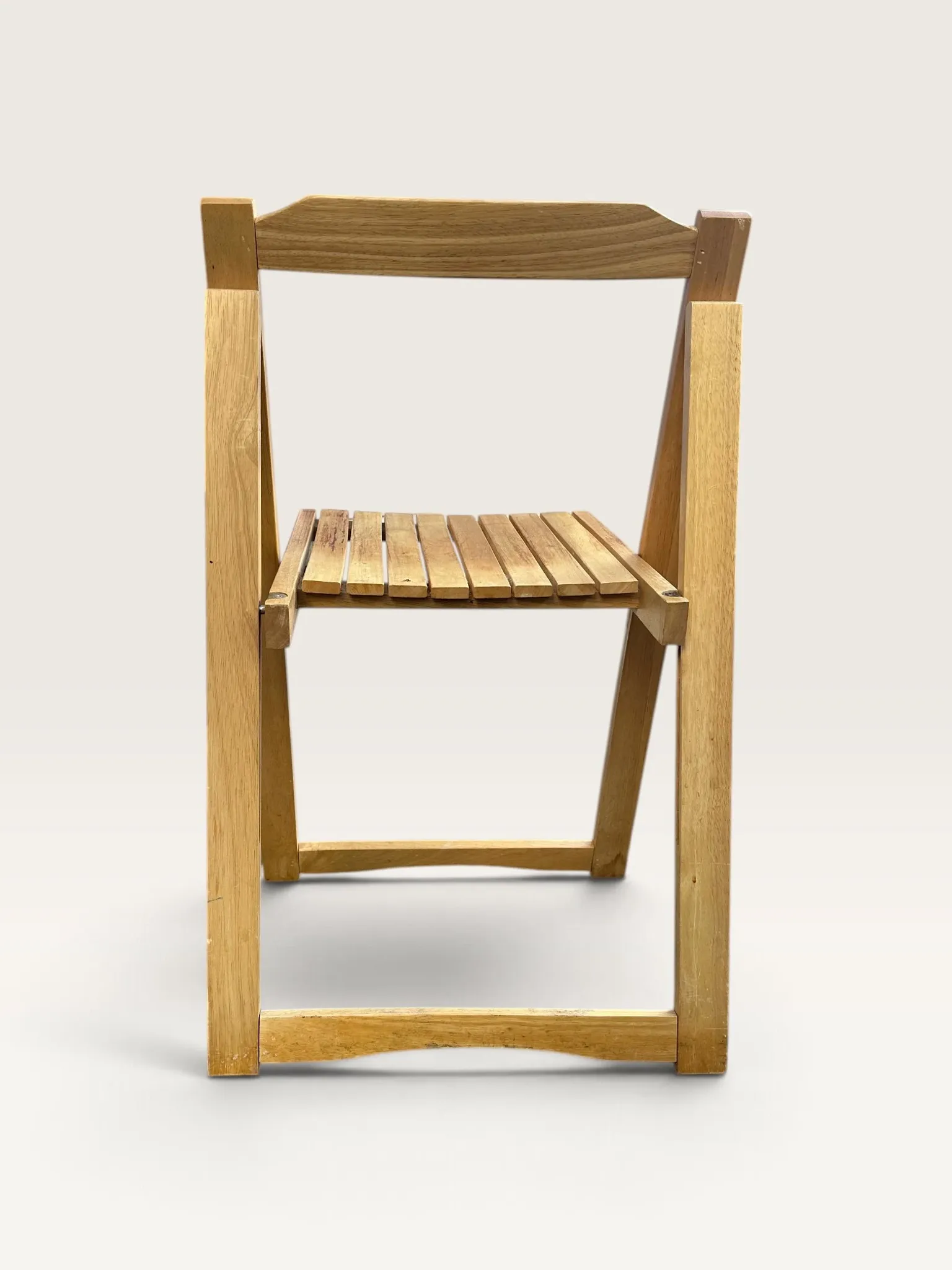 Blonde wooden folding chair in the style of Aldo Jacober.