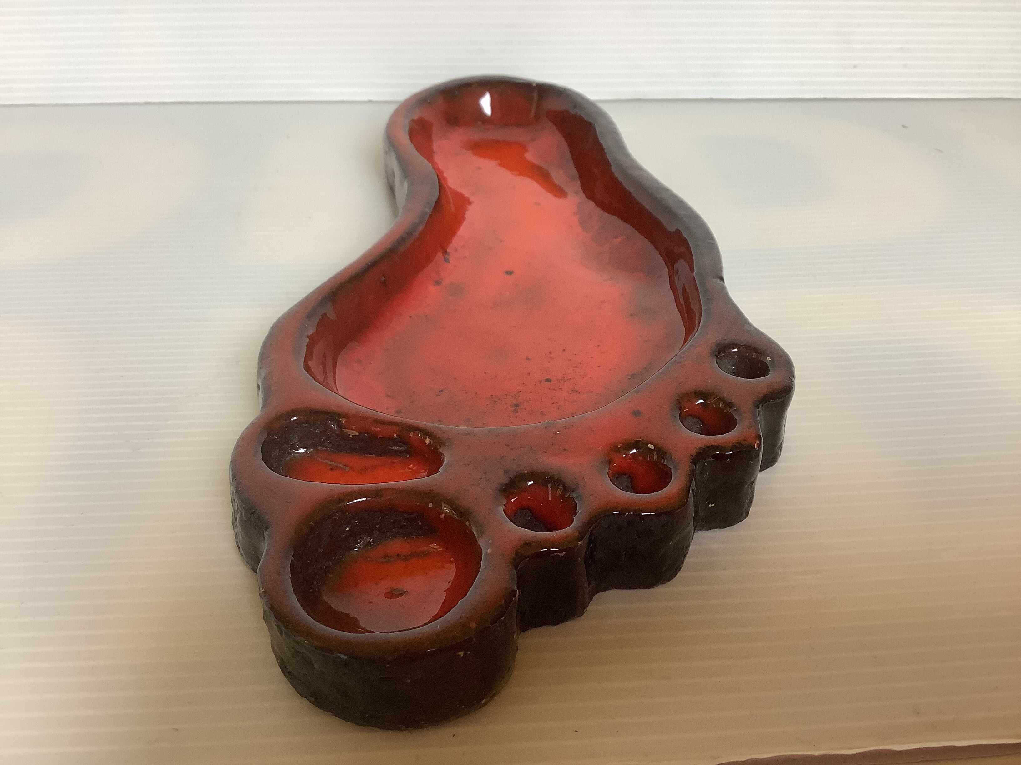 Red ceramic footprint catchall.