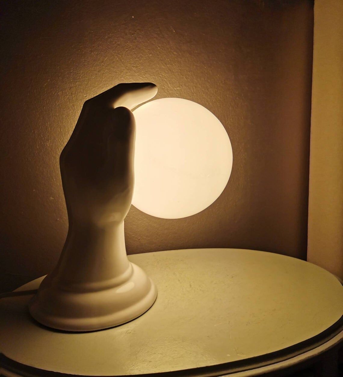 Hand-shaped ceramic wall lamp with 80s glass sphere