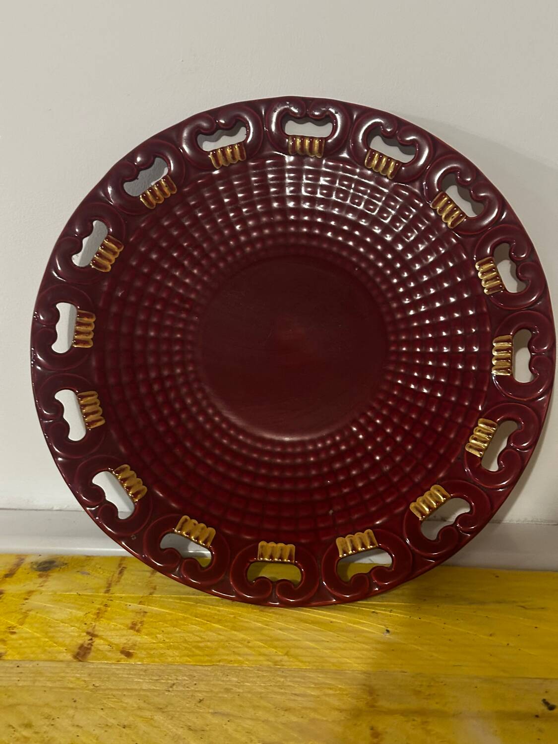 Burgundy and gold openwork plate in ceramic from Saint-Clement, 1950s.