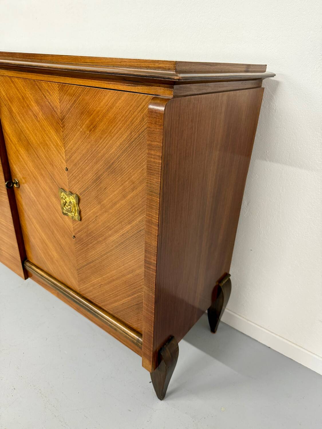 Antique art deco sideboard from the 1930s with veneered wood and bronze insert